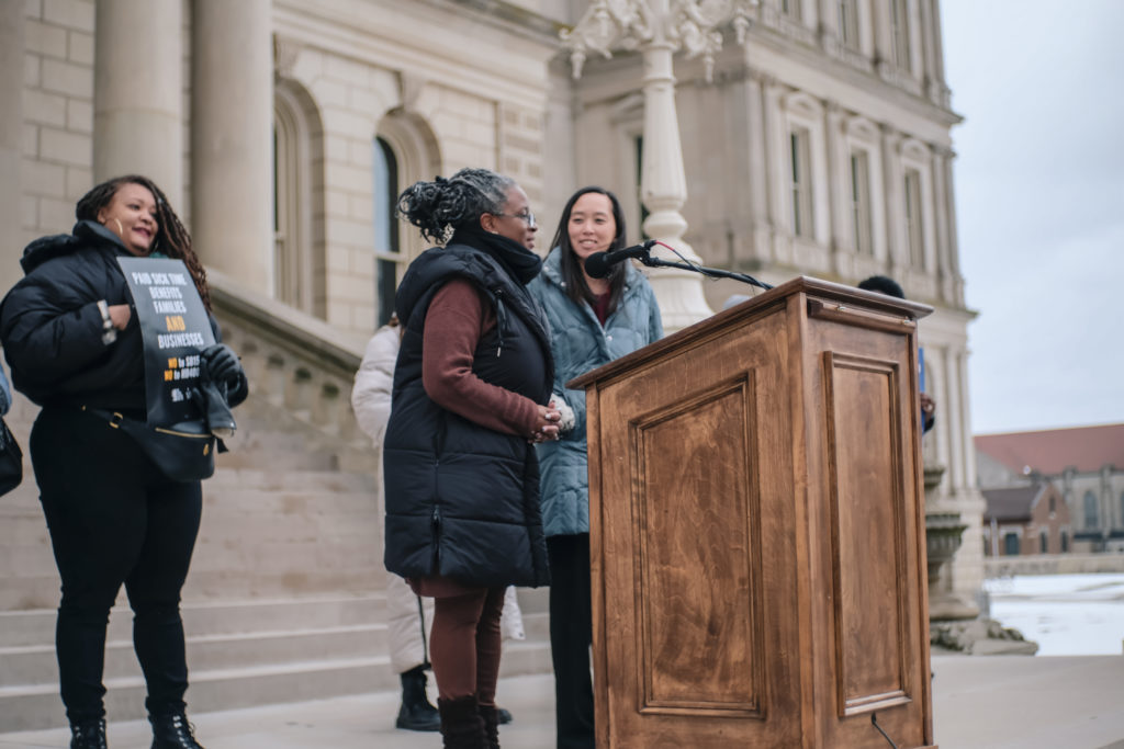 Two Michigan state senators speaking at podium on state capitol steps