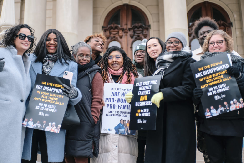 Michigan legislators and Mothering Justice staff and volunteers on the Michigan State Capitol steps speaking against proposed amendments to the Earned Sick Time Act, Jan. 29, 2025, Lansing, Michigan.