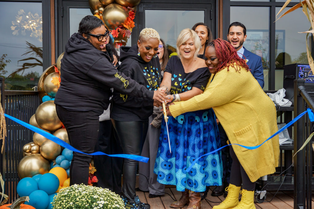 Four Birth Detroit co-founders at ribbon cutting at Detroit Birth Center opening