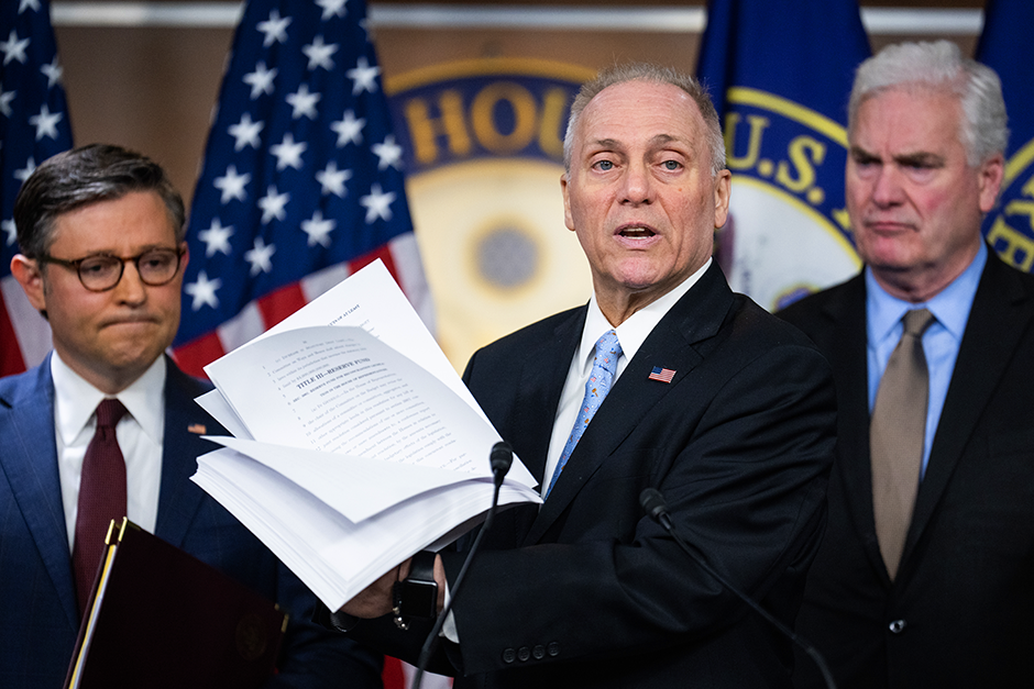 House Majority Leader Steve Scalise holding the House Republican budget during a February news conference with Speaker of the House Mike Johnson, left, and House Majority Whip Tom Emmer, right.