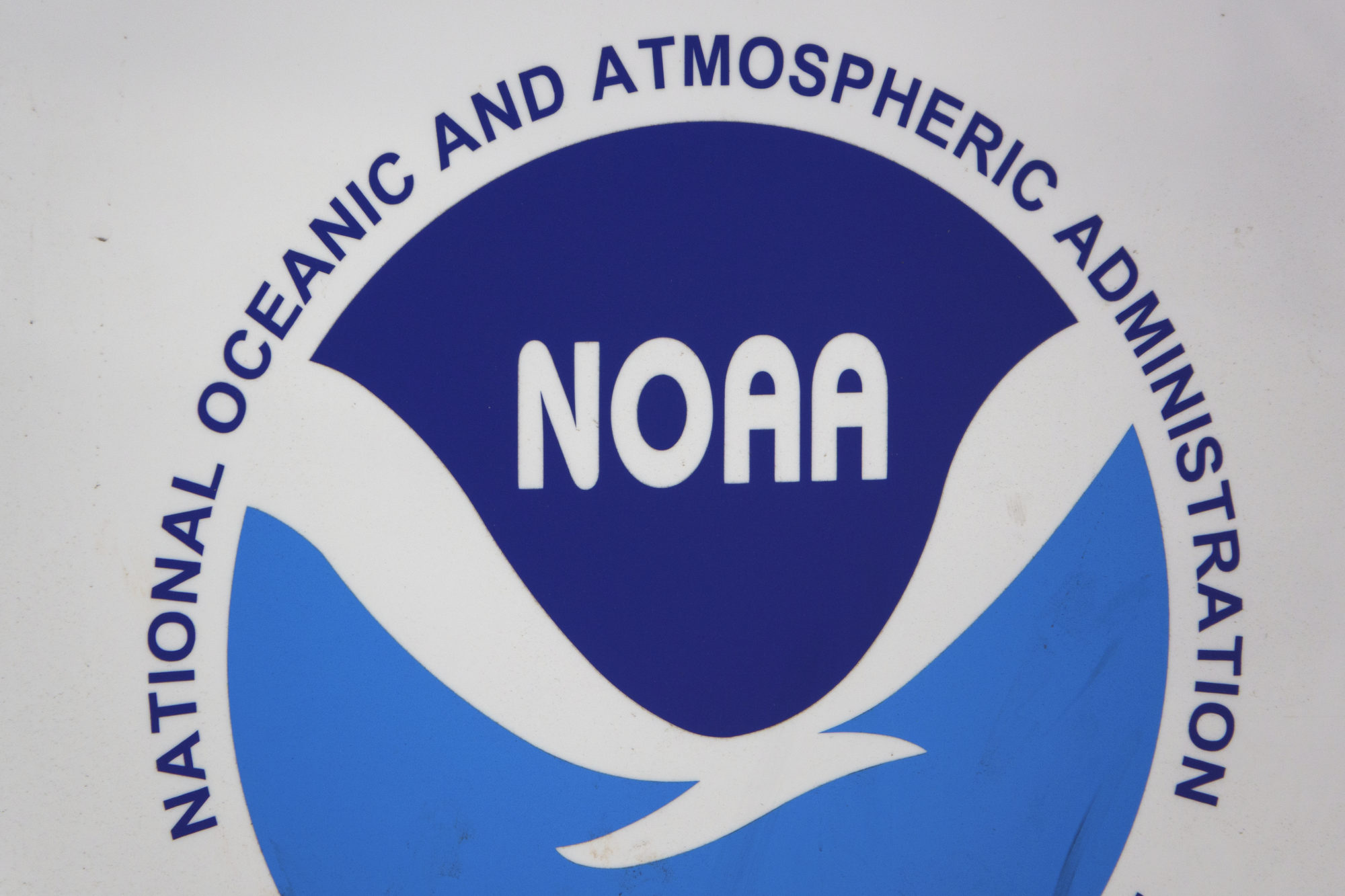 A sign displaying the National Oceanic and Atmospheric Administration logo outside a fisheries science center in San Diego.