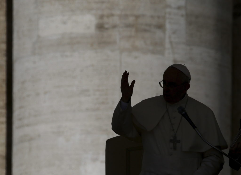 Pope Francis waves as he arrives to lead the general audience in St. Peter's Square at the Vatican