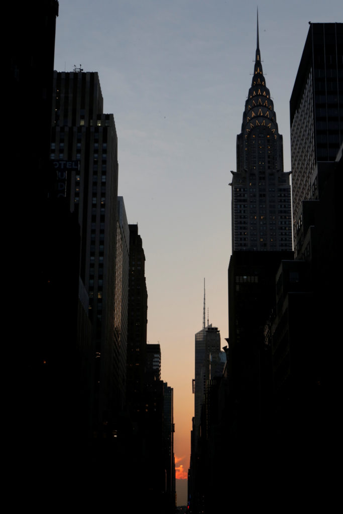 A cloud blocks the sunset on 42nd St in Manhattan during the phenomenon known as Manhattanhenge in New York City