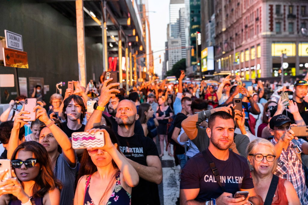 People gather to watch the sunset during the phenomenon known as Manhattanhenge in New York