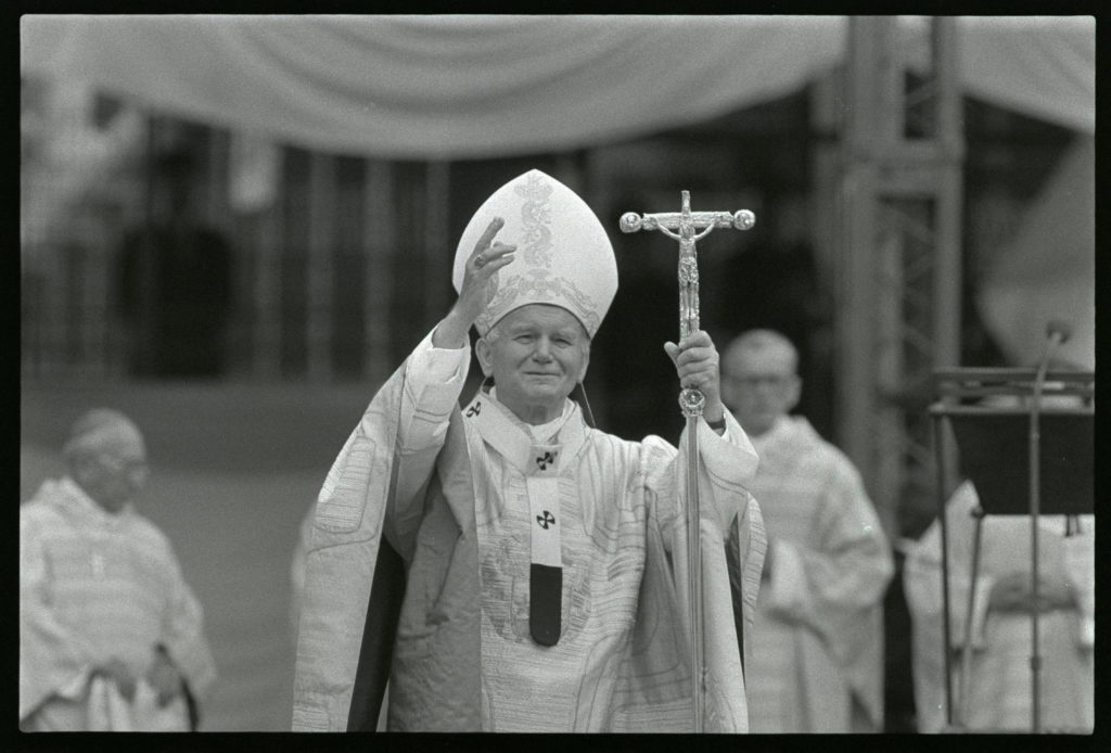 Pope John Paul II bleses the cheering crowd in Cologne football stadium.