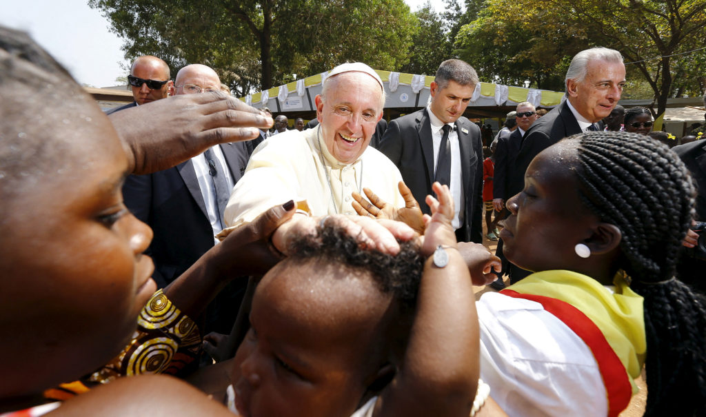 FILE PHOTO: Pope Francis blesses a child as he visits the refugee camp of Saint Sauveur in Bangui, Central African Republic