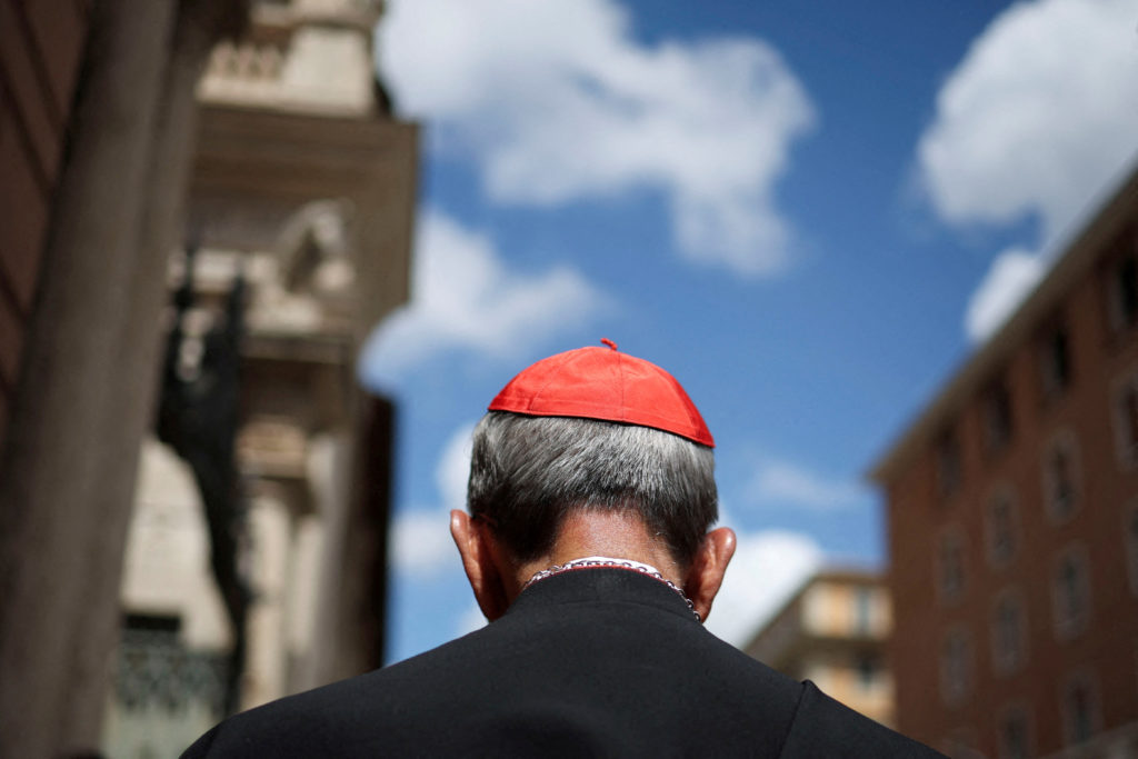Cardinals walk ahead of the conclave to elect the next pope