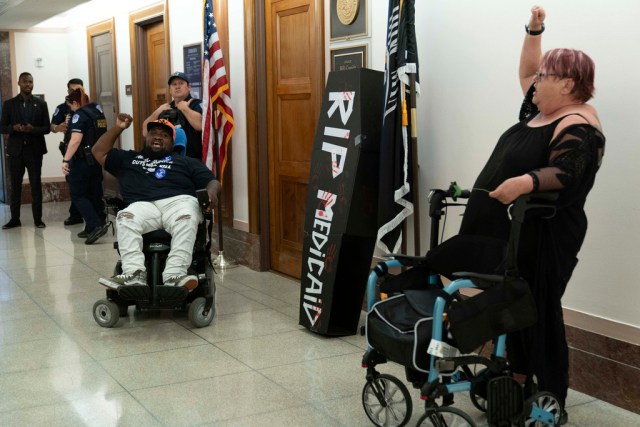 two protesters in wheelchairs
