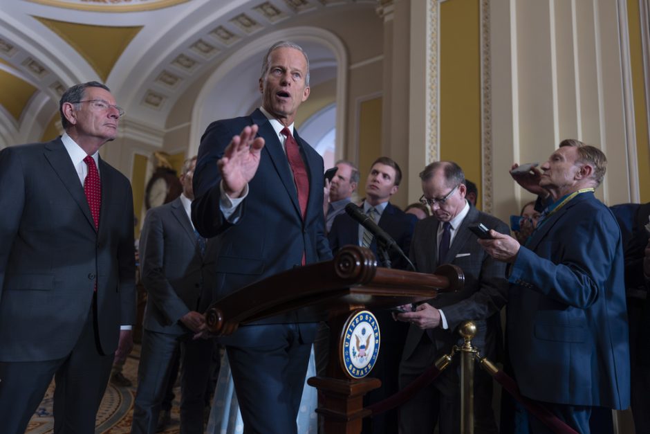 man in suit speaks at news conference