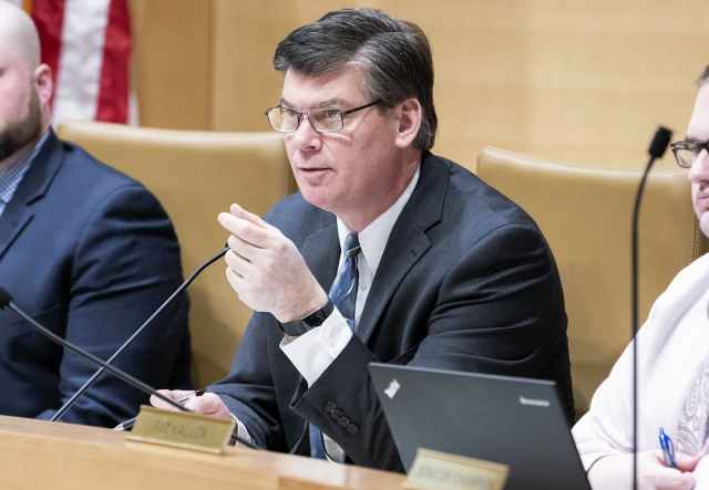 a politician sits in a suit