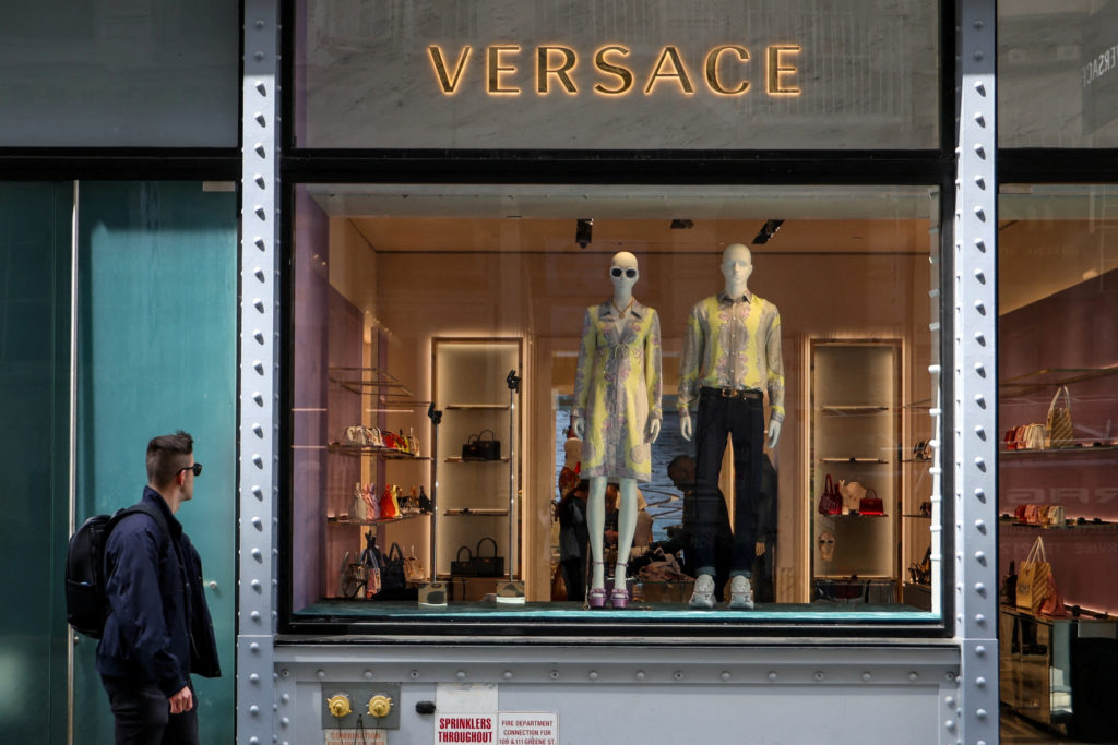 FILE PHOTO: A man walks by a Versace store in New York