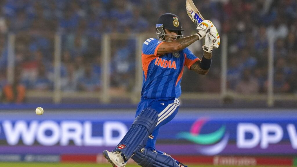Indian cricket player in blue uniform batting in a T20 World Cup match at Ahmedabad.