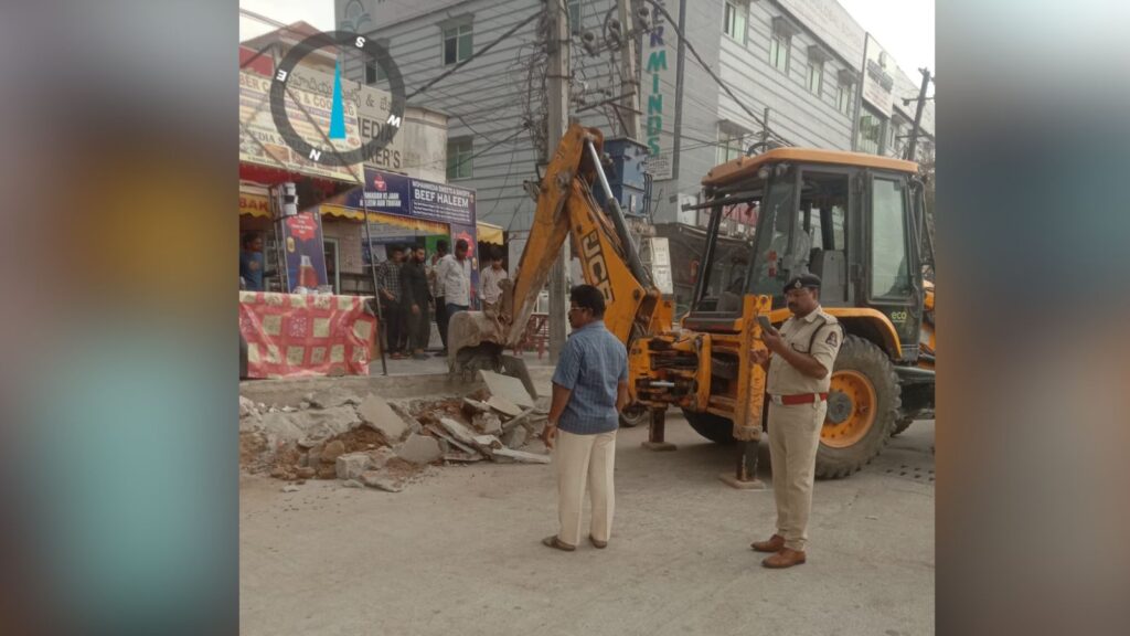 Construction work on a busy street with a backhoe loader and workers in an urban area.