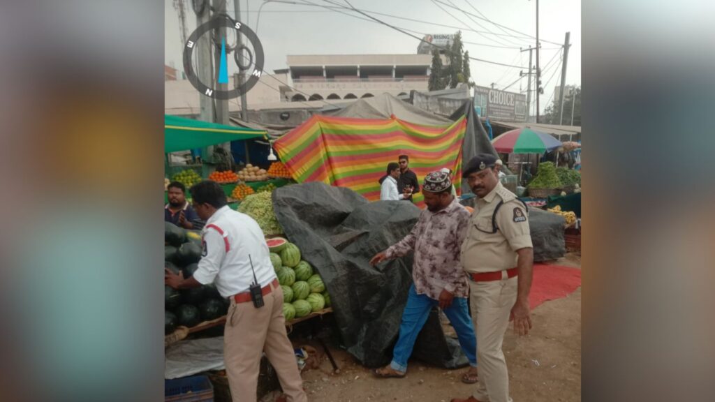 Market scene with vendors, police officers, and shoppers at The Siasat Daily market.