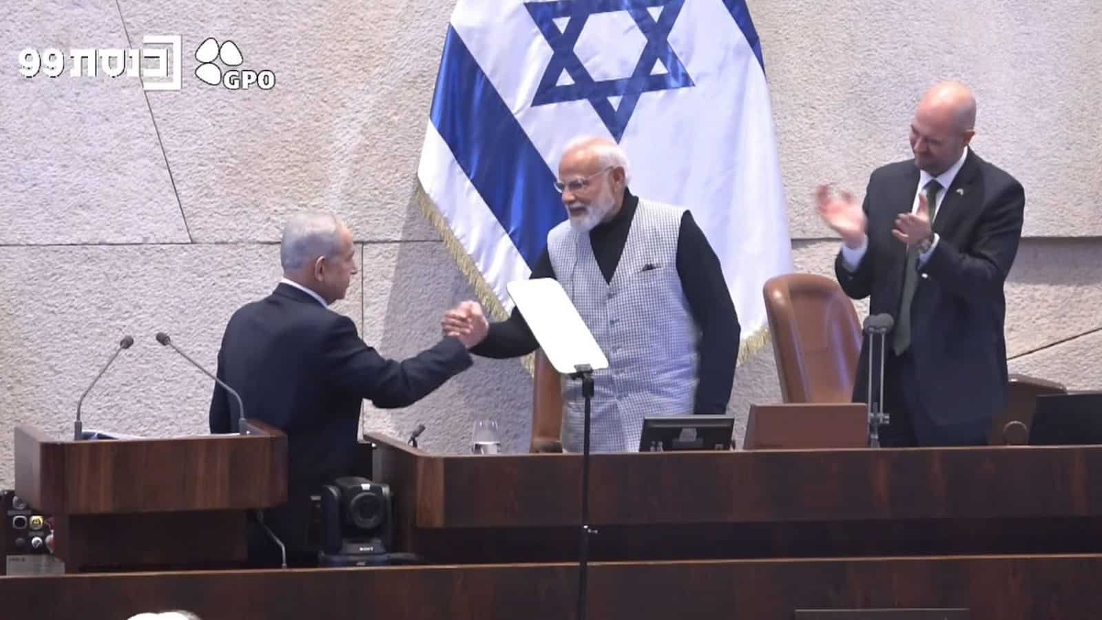 Indian Prime Minister Narendra Modi and Israeli officials shake hands during a formal event.