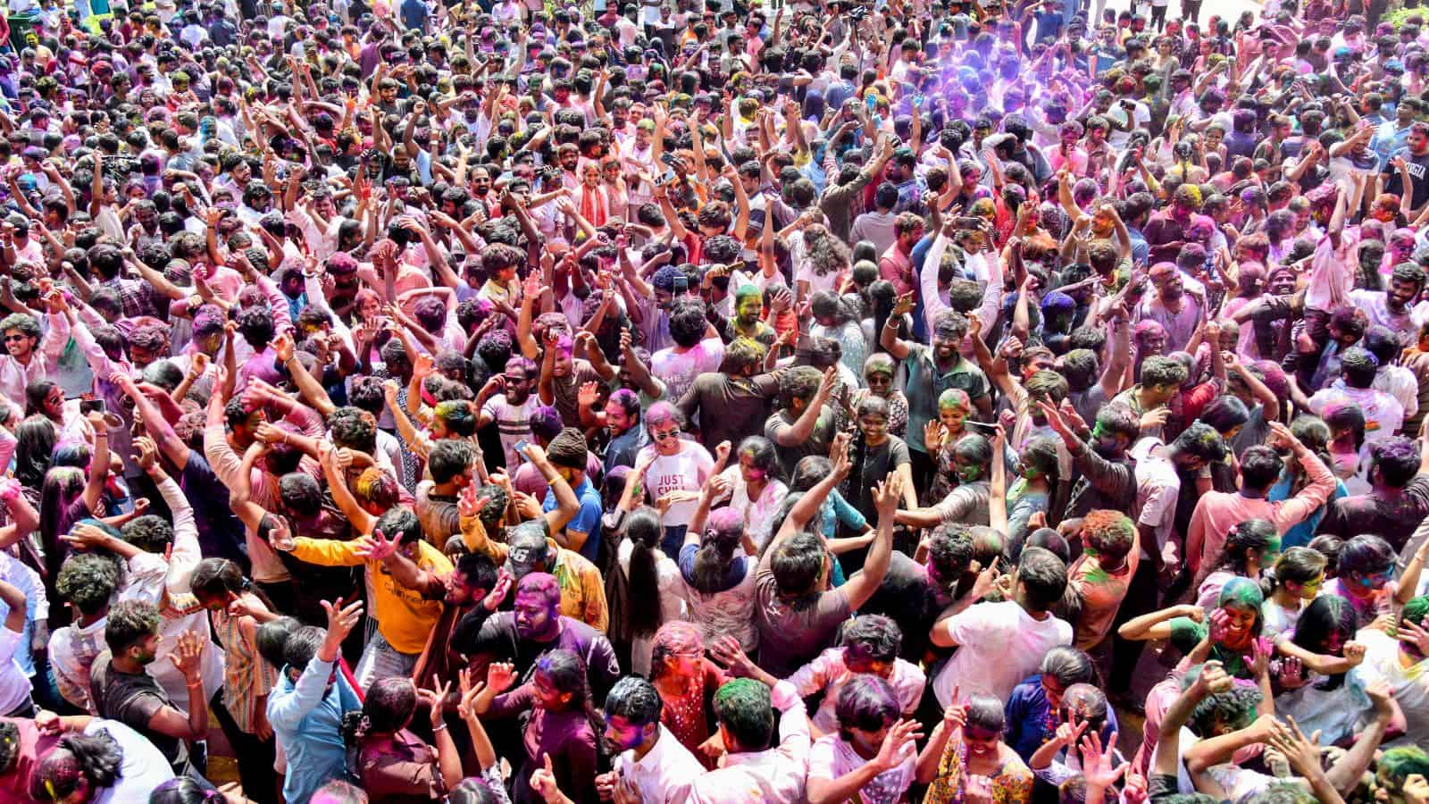 People celebrating Holi in Telangana with colourful powders and festive spirit.