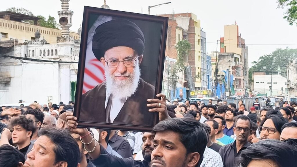 Crowd gathers in Old City holding a portrait of Iran's Khamenei during a protest rally.