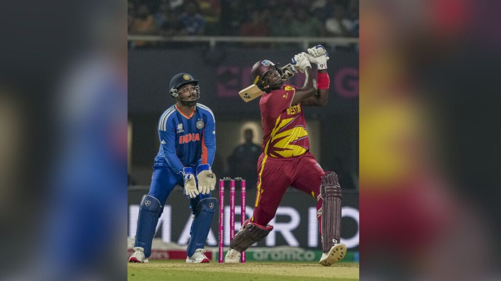 West Indies batsman in action during a T20 World Cup match against India, with a fielder nearby.