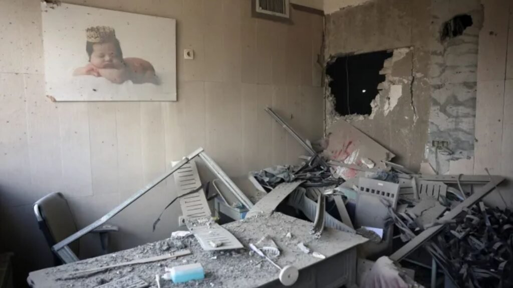 Explosion damage in an indoor space with debris, broken furniture, and structural damage.