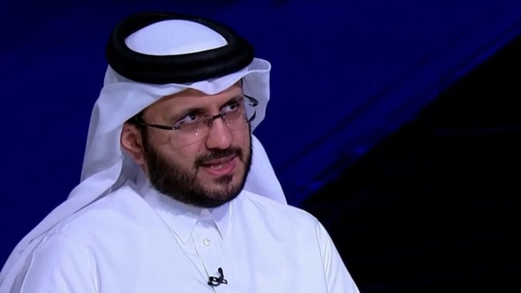 Man in traditional Qatari attire speaking at a UN event.