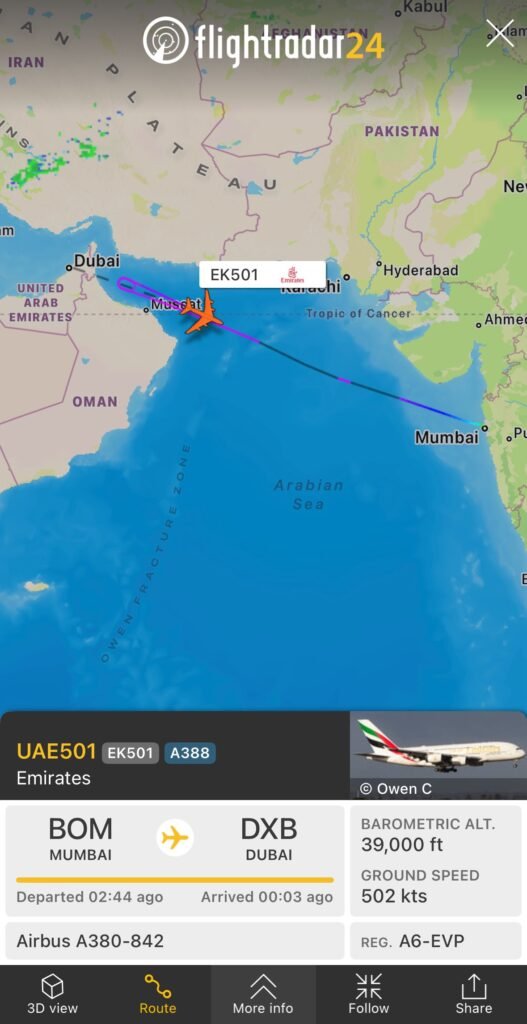 FlightRadar24 map shows Emirates flight EK501 turning back toward Mumbai over the Arabian Sea.